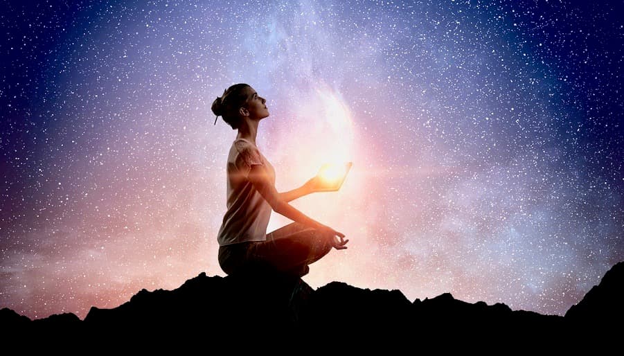 Woman sitting Outside Holding White Light in her Hand