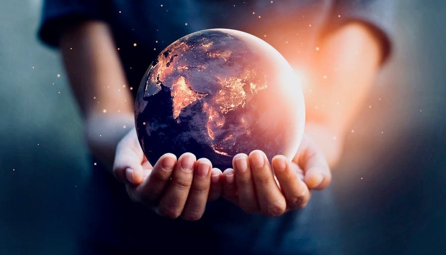 Hands Holding Earth Glowing