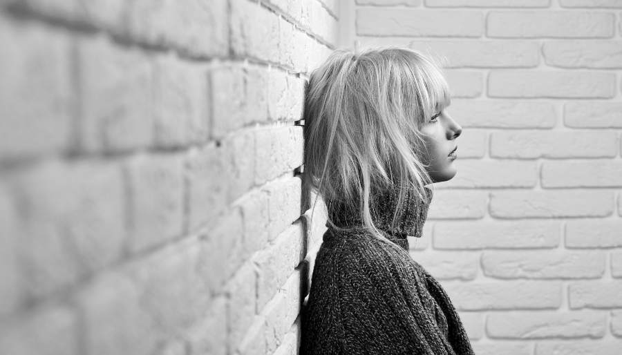 Anxious Woman leaning on a wall