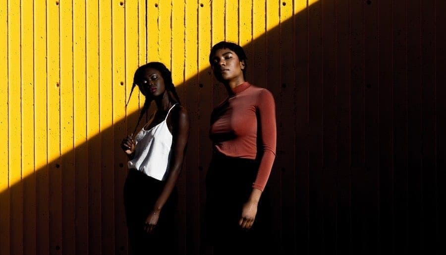 2 Girls Standing in Shadow