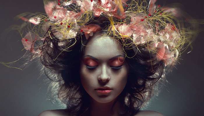 meditating woman with floral, autumn themed hair