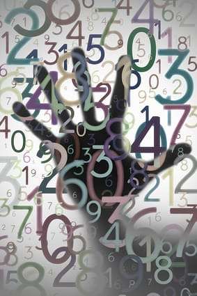 Hand behind colorful numbers Can Numerology Be Considered A Paranormal Phenomenon?