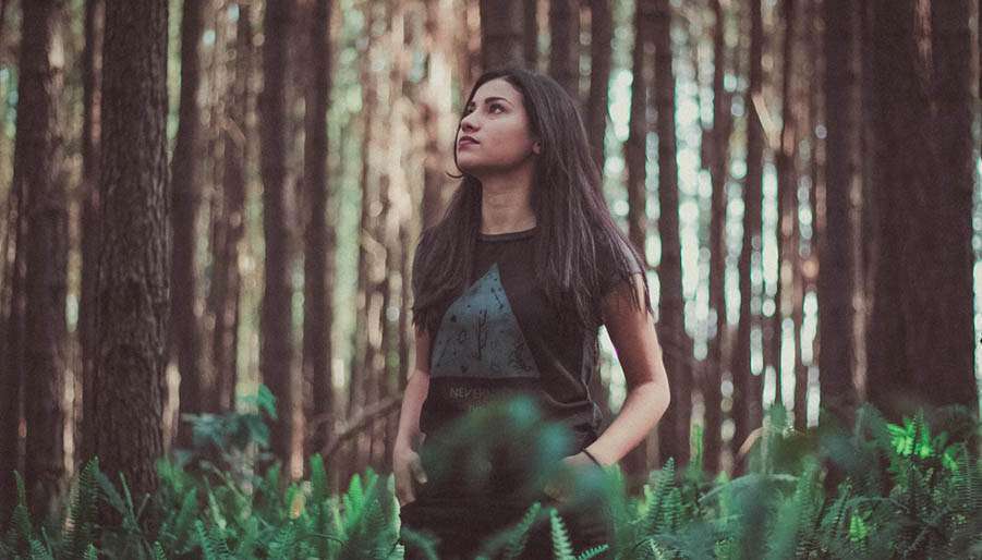 rewilding woman walking in forest