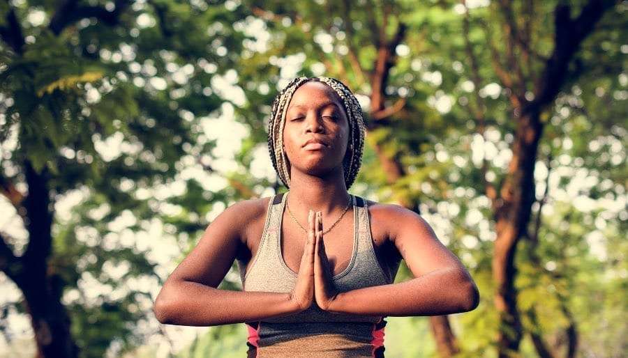 ACHIEVEMENT NUMBER 4 WOMAN OF COLOUR DOING YOGA