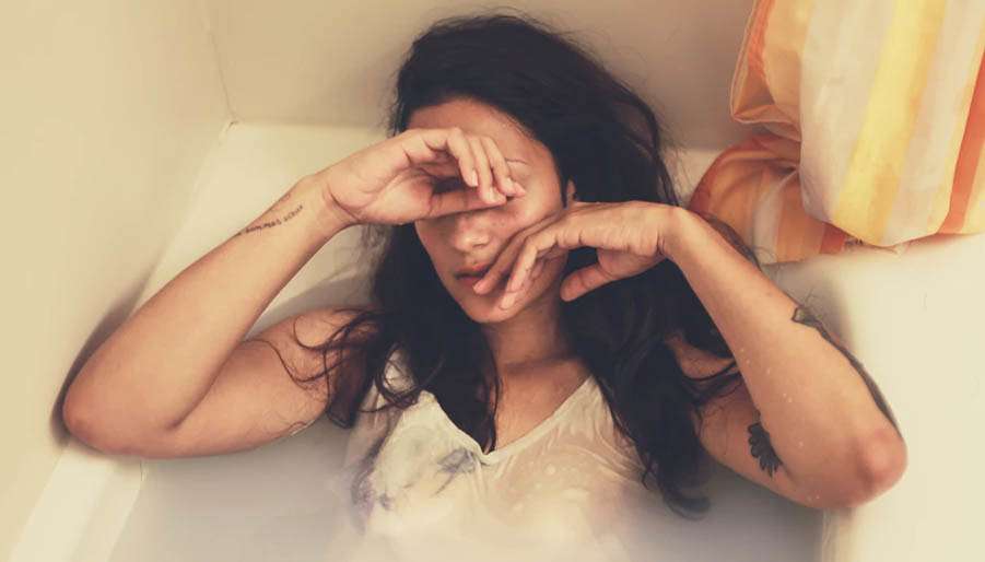 pisces-are-ridiculous Emotional lady laying in a bath tub with clothes on
