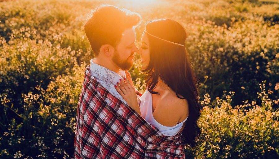 Venus-in-Cancer Couple Embracing Closely in Sunset Field of yellow flowers