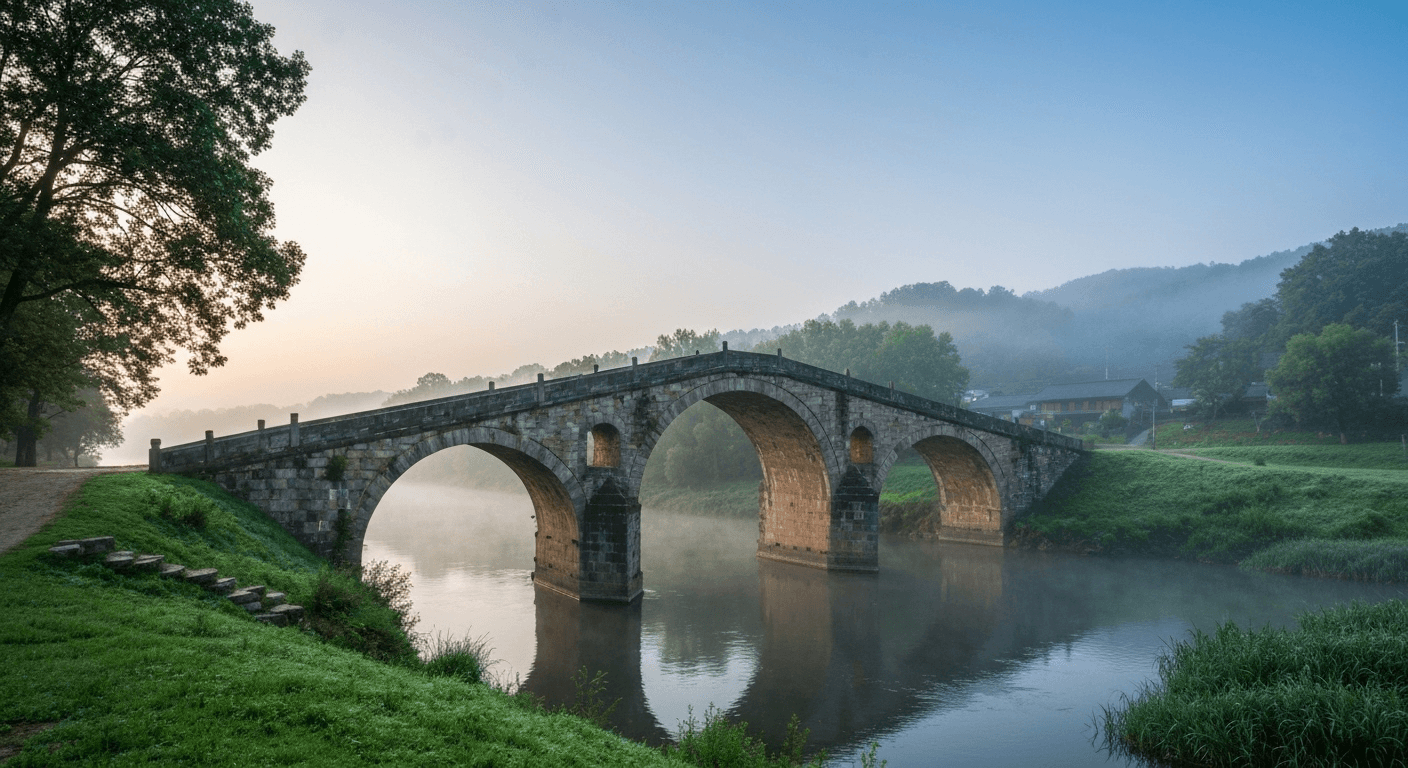 Ancient stone bridge spanning misty river valley. Ancient stone bridge spanning misty river valley.